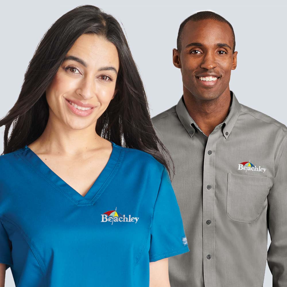 Woman in decorated blue scrub and man in button down dress shirt.