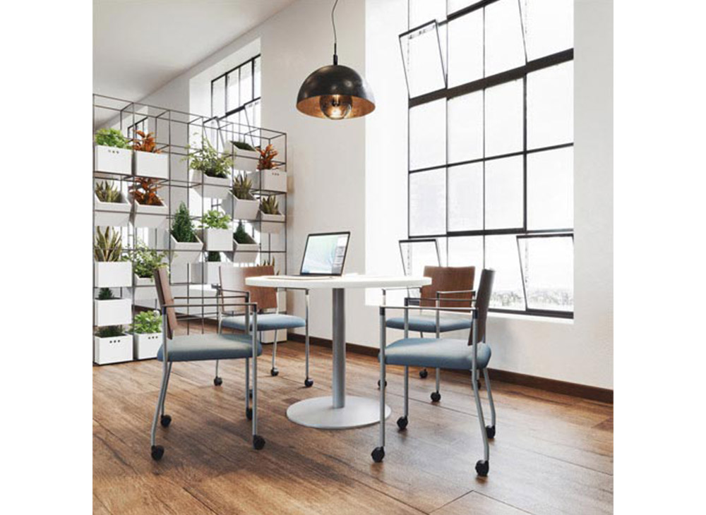 Small meeting area with white circle table and mobile minimal frame chairs