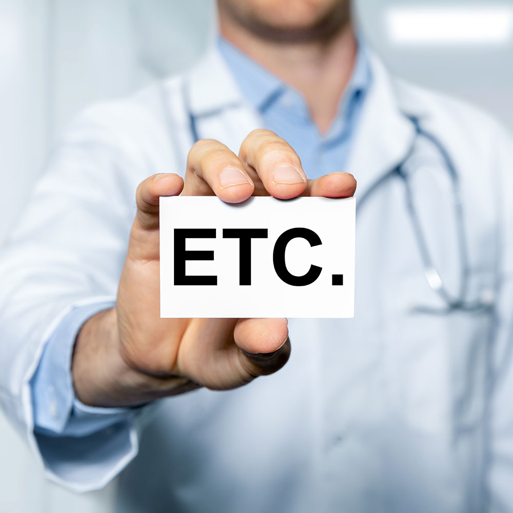 Doctor holding a card saying ETC.