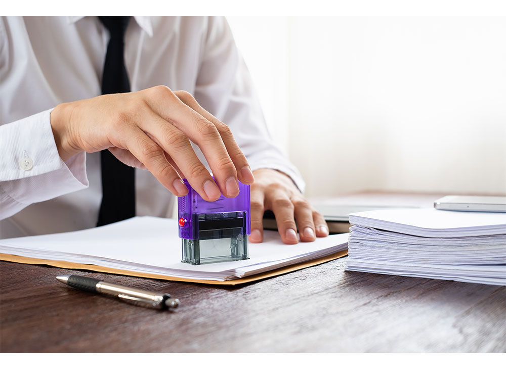 Business man using self inking signature stamp