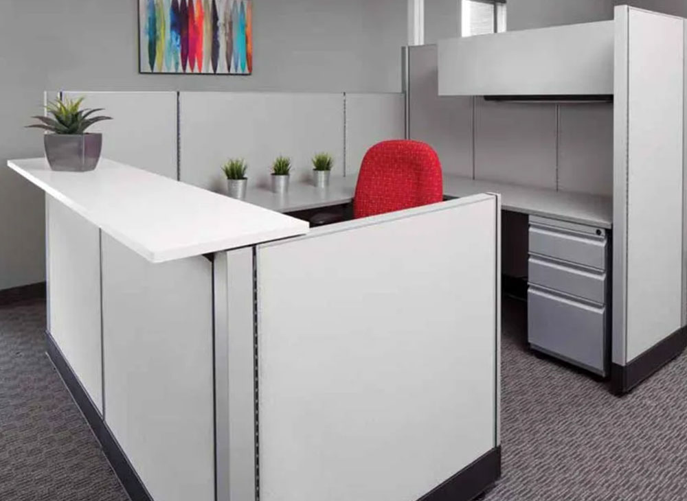 Cubical reception desk with light grey with black accents. Bright red task chair