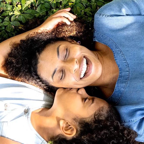 The Giving Purpose Project - Mother and Daughter laying down head to head