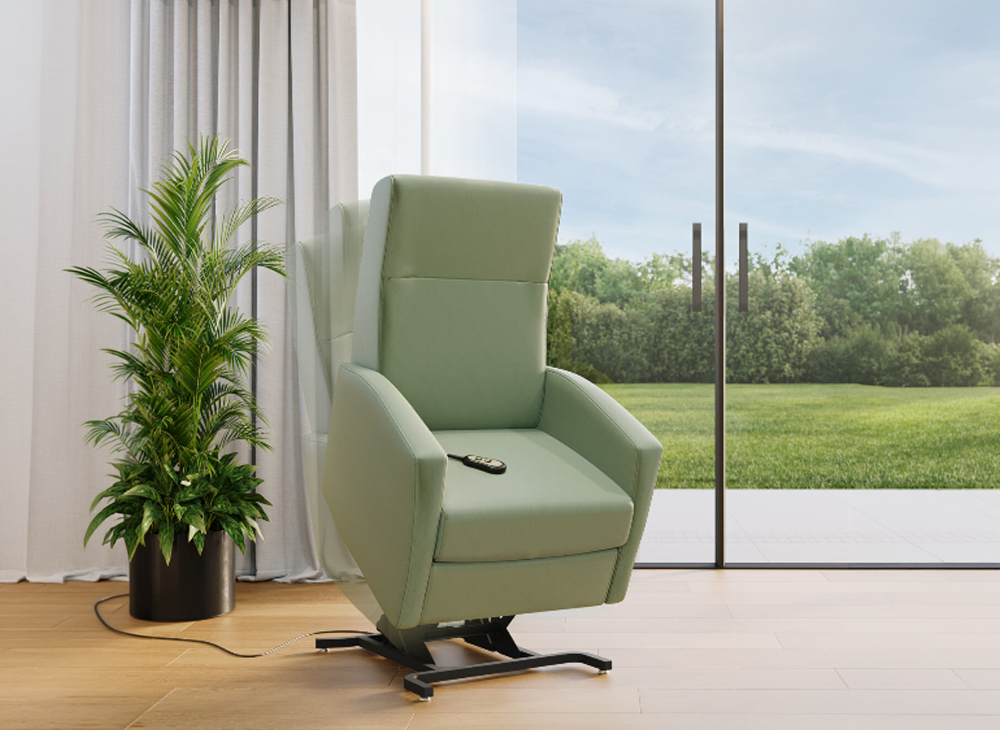 Sage green lift and reclining chair for easier sit to stand movement for the patient. The background accents the chair with luscious green tall potted plant, warm grey floor length curtains that are drawn to reveal a full length double glass door that lead to a beautiful rolling hill and tree line.