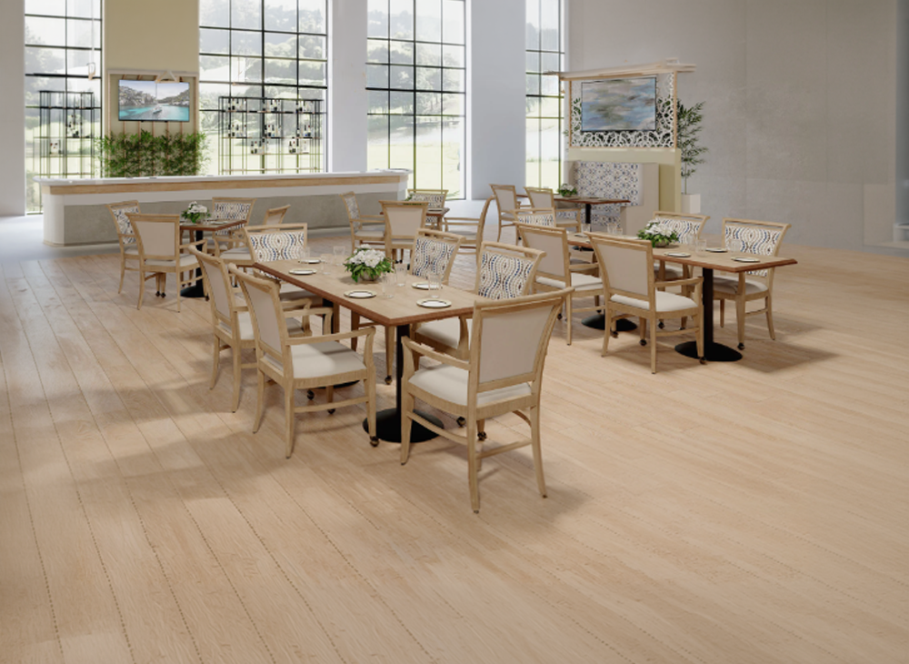 Dining room setup with warm neutral browns and warm pastel blues mixed into the fabric arm chairs, modular tables with tan tabletops to match and supported by black center supports.